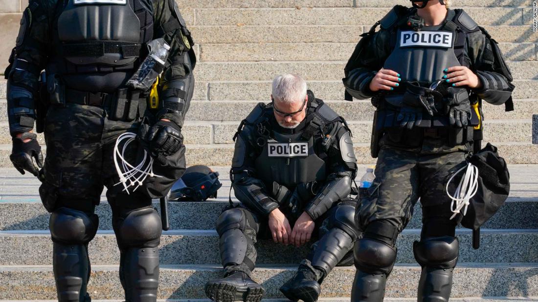 Police are pictured in riot gear outside the Kenosha County Courthouse on August 24.