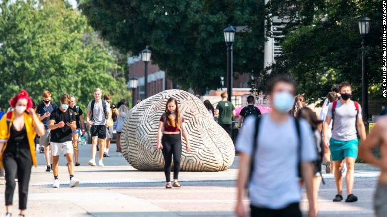 Students wear face masks Monday on the University of Iowa campus in Iowa City, Iowa.