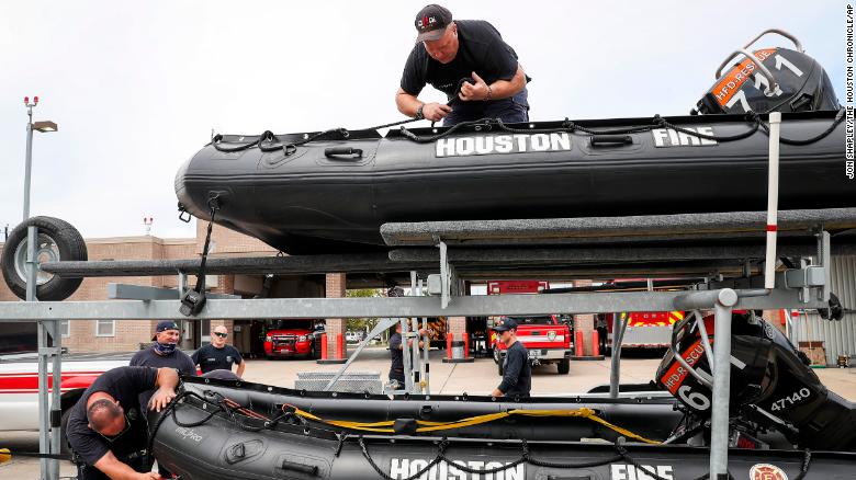 Tropical Weather
Engineer Operator Karl Carmack, left, firefighter Paul Kessler, top, and other Houston firefighters prepare water-rescue equipment Monday.