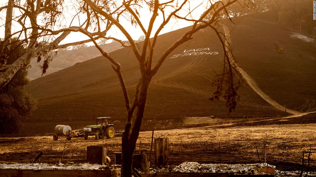 A sign reading &quot;Vaca Strong&quot; adorns a charred hillside in Vacaville, California, on August 24.