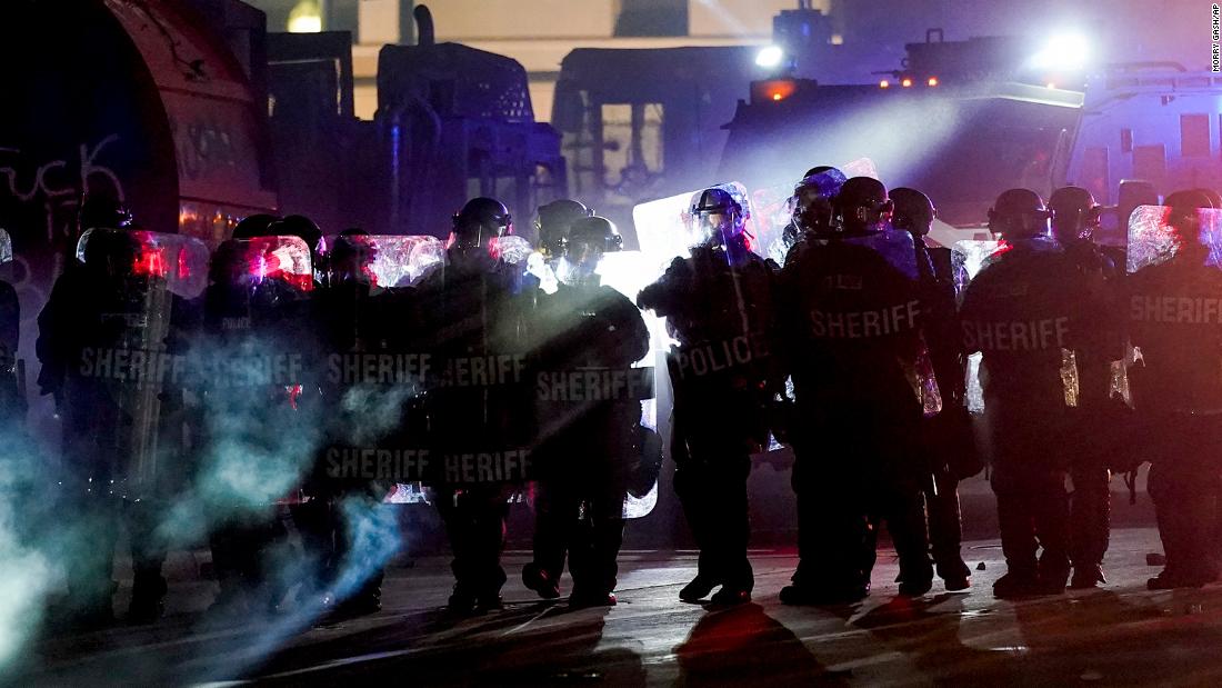 Authorities disperse protesters from a Kenosha park on August 25.