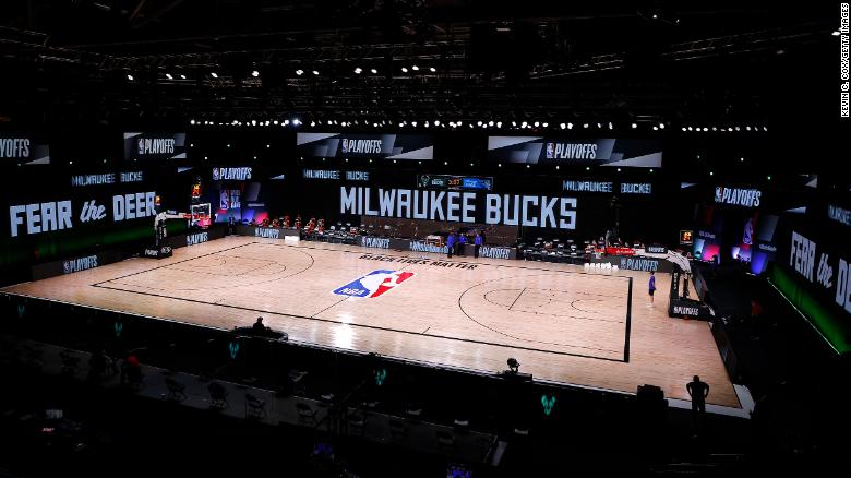 An empty court and bench is shown before the start of a scheduled game between the Milwaukee Bucks and the Orlando Magic.