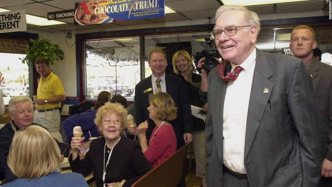 Buffett arrives at an Omaha Dairy Queen to autograph books and chat with Berkshire Hathaway shareholders in 2002. Many people were in Omaha for Berkshire Hathaway&#39;s annual shareholders meeting, which has been described as &quot;the Woodstock of Capitalism.&quot;