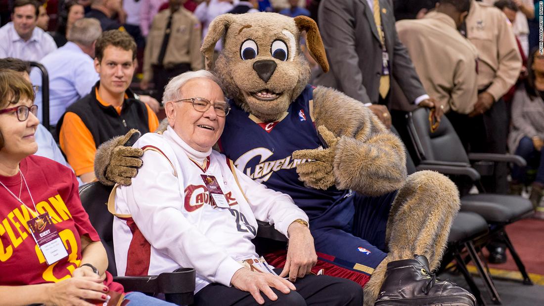 Buffett goofs off with Cleveland Cavaliers mascot Moon Dog prior to an NBA game in 2014.