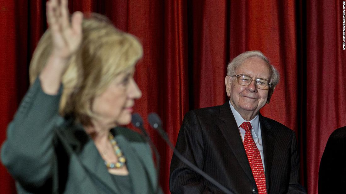 Buffett listens as presidential candidate Hillary Clinton speaks during an event in Omaha in 2015. Buffett said at the rally that he was supporting Clinton&#39;s bid for president because they share a commitment to help the less affluent.