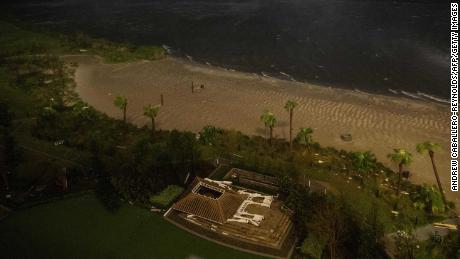 The remnants of a flattened building lie near a beach as the eye wall of Laura passes over Lake Charles, Louisiana. 