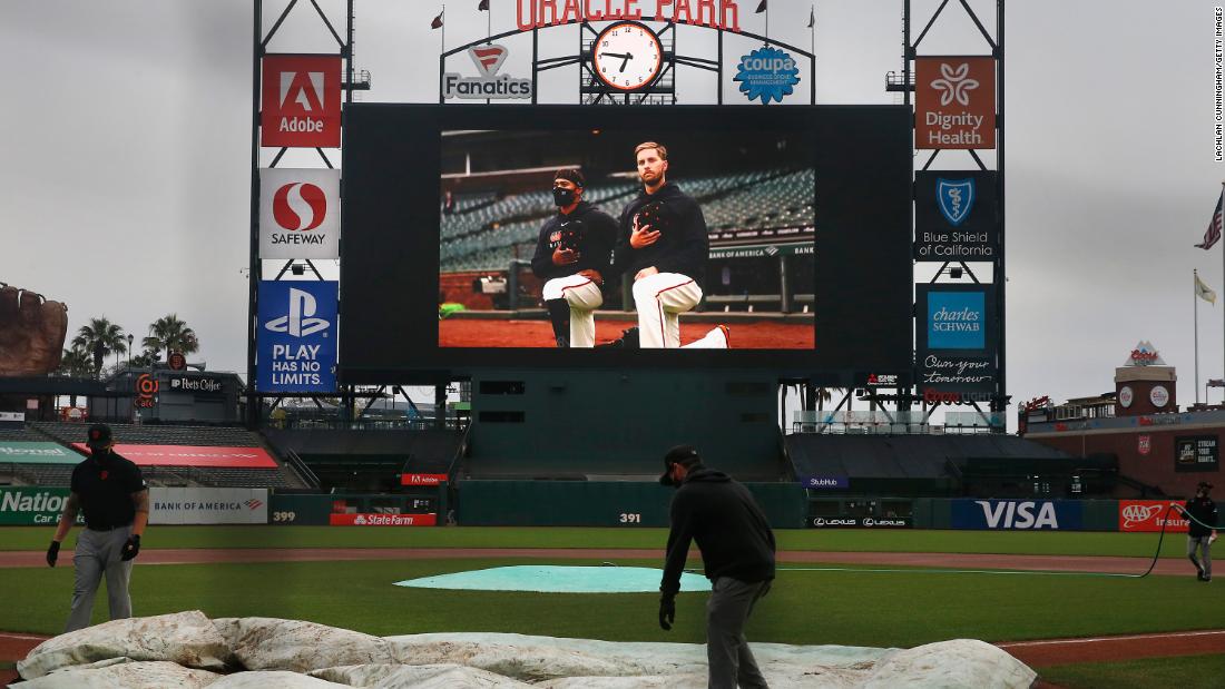 A grounds crew covers the field at San Francisco&#39;s Oracle Park after a Major League Baseball game was postponed on August 26.