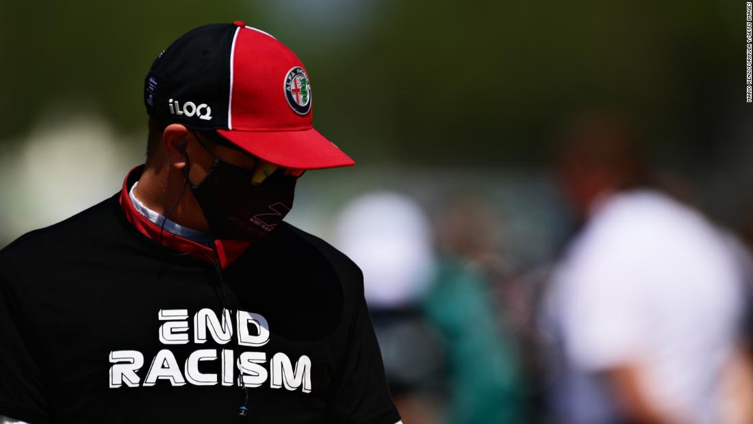 Formula One driver Kimi Raikkonen wears an &quot;end racism&quot; shirt before a race in Barcelona, Spain, on August 16.