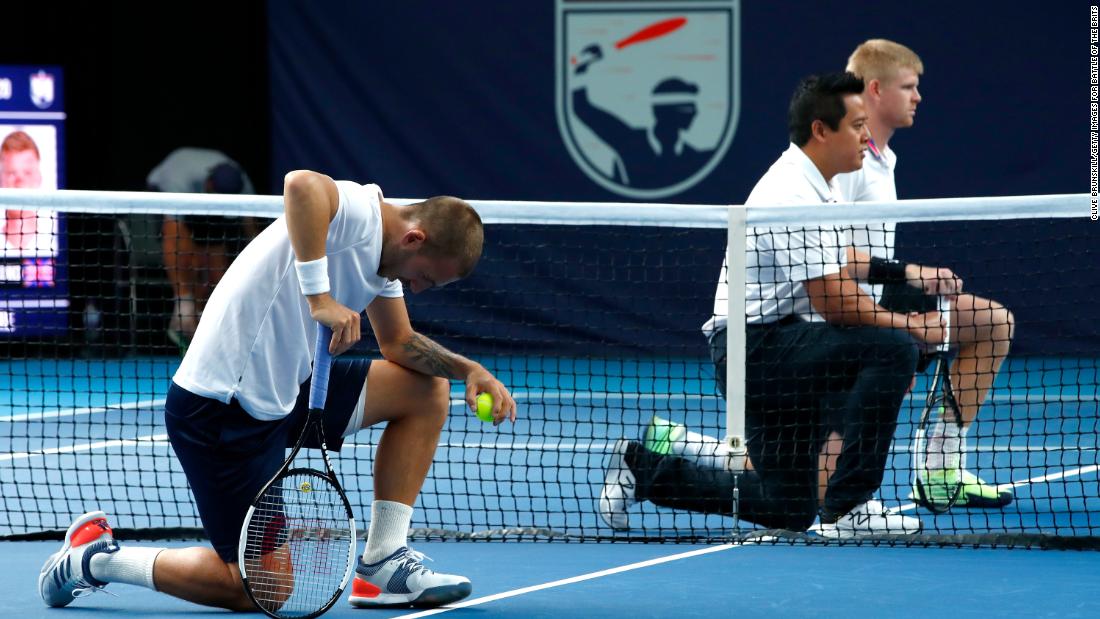 Tennis players Dan Evans and Kyle Edmund join match umpire James Keothavong in taking a knee in London on June 28.