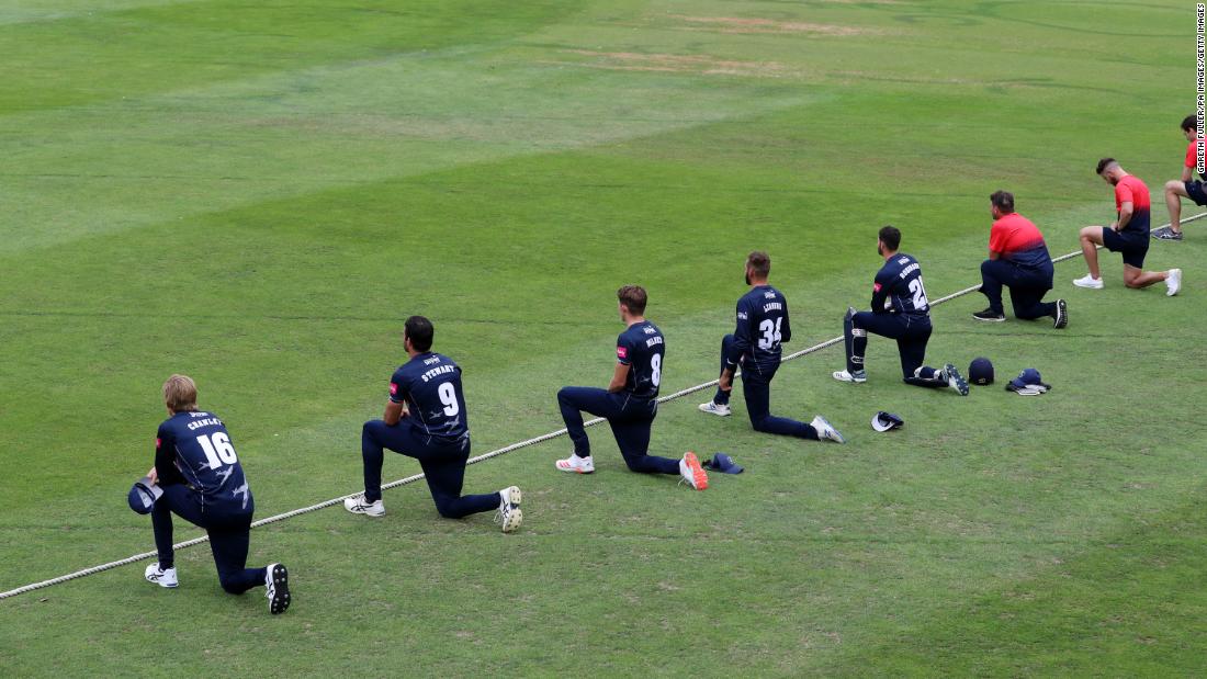 Cricketers with the Kent Spitfires take a knee during a match in Canterbury, England.