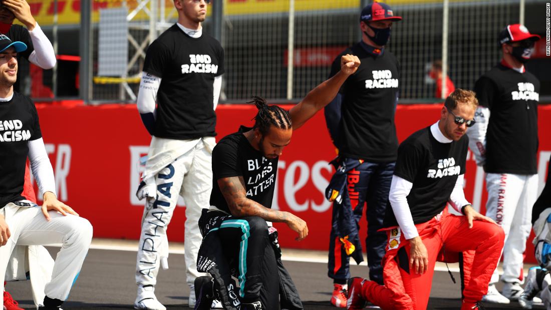 Formula One champion Lewis Hamilton raises his fist before a race in Northampton, England, on August 9.