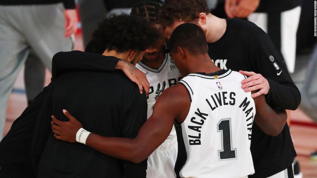 Members of the San Antonio Spurs huddle before a game against Sacramento on July 31.