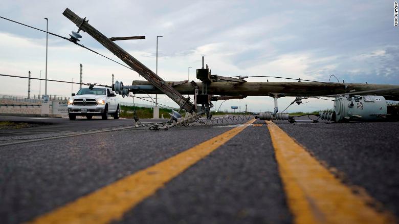A power line downed in Hurricane Laurea stretches across a road in Sabine Pass. 