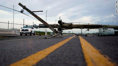 A power line downed in Hurricane Laurea stretches across a road in Sabine Pass. 