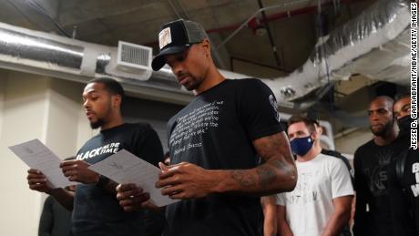 Sterling Brown and George Hill of the Milwaukee Bucks read a statement to the media on August 26.