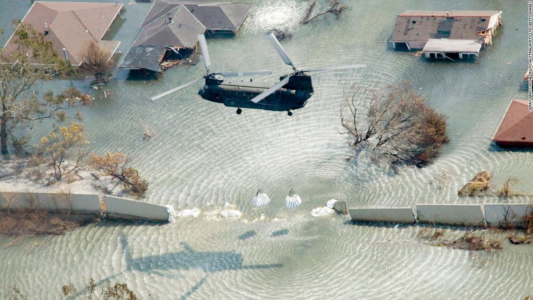 A helicopter drops sandbags to plug a levee in New Orleans on September 11, 2005.