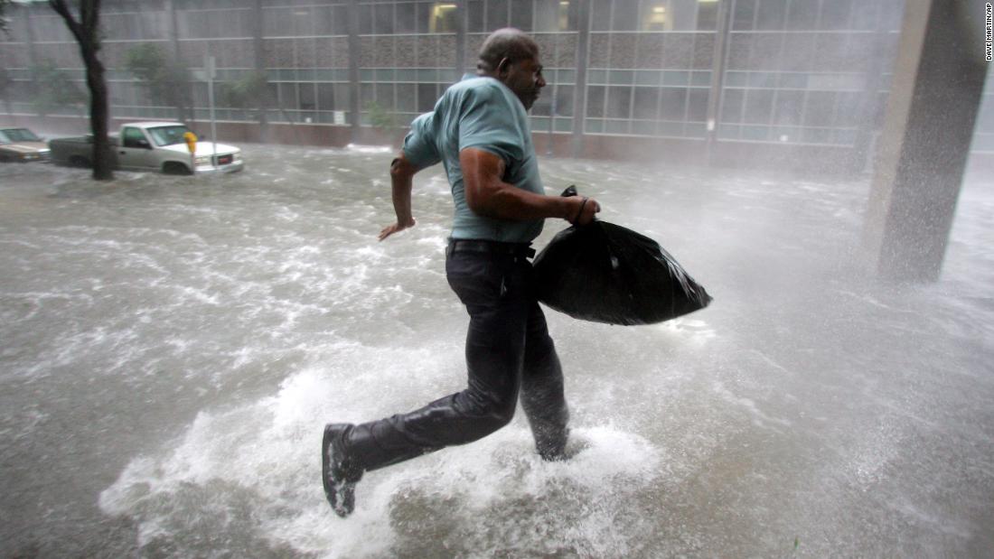 Arnold James tries to keep his feet as a strong gust nearly blows him over in New Orleans. The roof on his home blew off, forcing him to seek shelter at the Superdome.