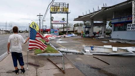 A man walks by debris at a Lake Charles gas station on Thursday.