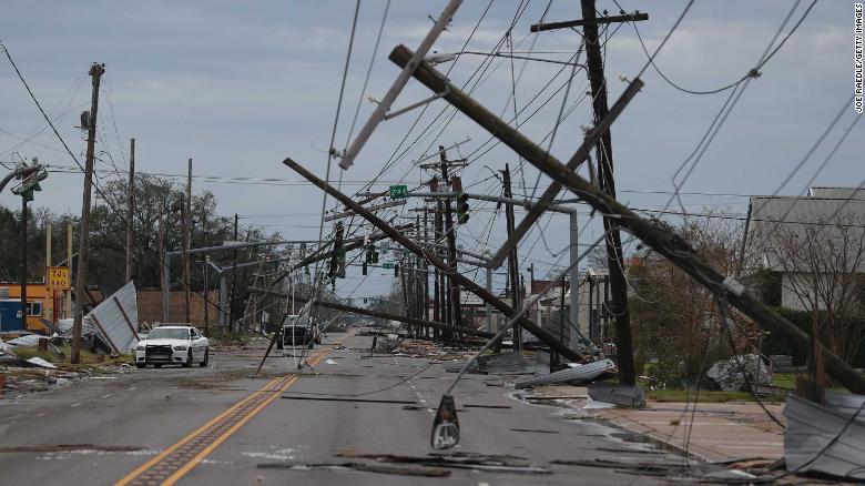 A Lake Charles street is  strewn with debris and downed power lines Thursday after Laura passed through.