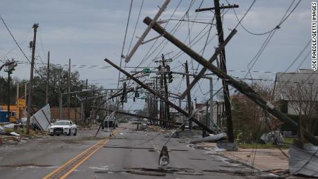 A Lake Charles street is  strewn with debris and downed power lines Thursday after Laura passed through.