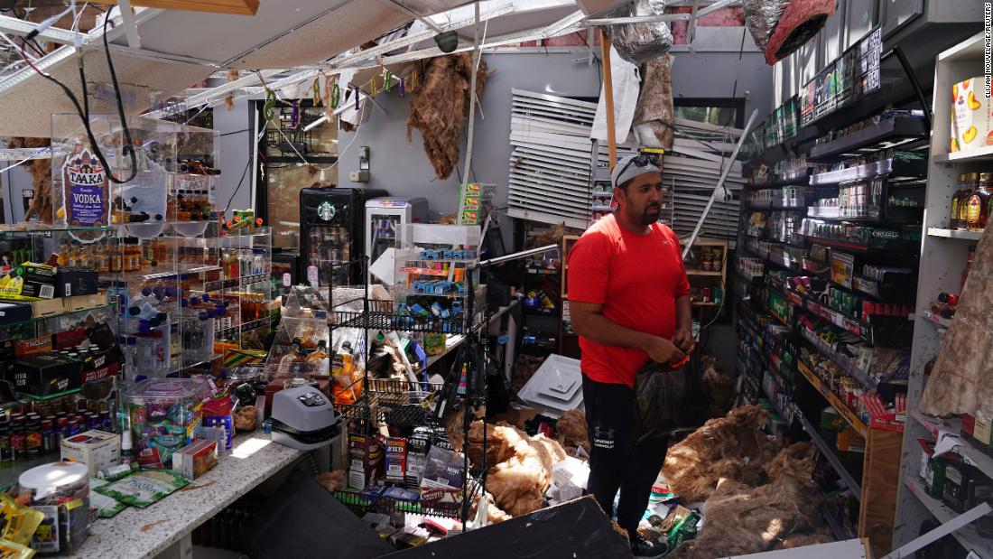 Ahmed Nawaz looks at the damage in his store in Lake Charles on August 27.