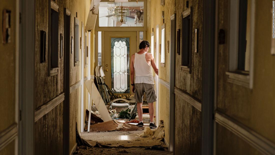 A man walks through a debris-filled hallway on the second floor of a Lake Charles church that lost its roof on August 27.