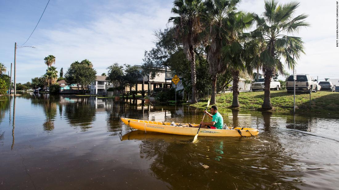 Martin Almanza paddles a canoe through a flooded section of Galveston, Texas, on August 27.