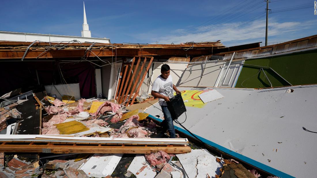 Benjamin Luna helps recover items from the children&#39;s wing of the First Pentecostal Church in Orange, Texas, on August 27.