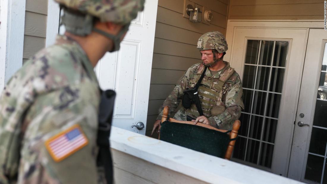 Louisiana National Guard Pfc. Devin Lejeune helps search a Lake Charles apartment complex for people in need.