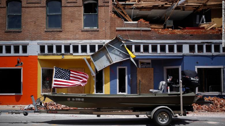 A U.S. flag flies on a boat parked in front of a damaged building after Hurricane Laura made landfall in Lake Charles, Louisiana, U.S., on Thursday