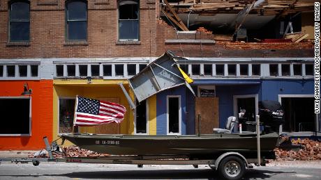 A U.S. flag flies on a boat parked in front of a damaged building after Hurricane Laura made landfall in Lake Charles, Louisiana, U.S., on Thursday