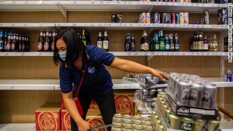  An employee restocks cases of beer at a supermarket the night before a citywide alcohol ban on April 9 in Bangkok, Thailand. 
