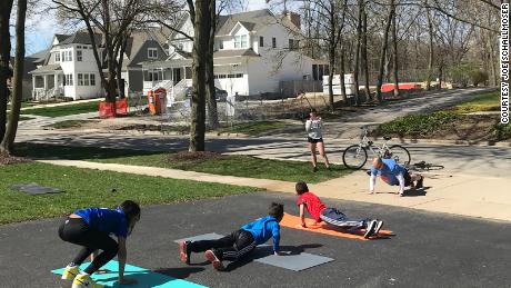 Joe Schallmoser (far right), athletic director at Avery Coonley School in Downers Grove, Ill., traveled to his students' homes to do burpees in their driveways while social distancing.