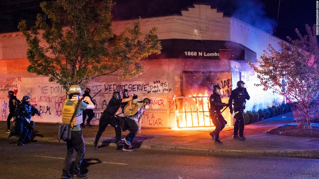 Police disperse a crowd after protesters &lt;a href=&quot;https://www.cnn.com/2020/08/29/us/portland-protests/index.html&quot; target=&quot;_blank&quot;&gt;set fire to the Portland Police Association building&lt;/a&gt; early in the morning on August 29. &lt;em&gt;(Editor&#39;s note: Part of this photo has been blurred because of profanity.) &lt;/em&gt;