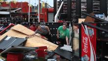 Rachel Ellis (left) and J&#39;Nay Fitch salvage items from the AutoZone store where they worked in Lake Charles, Louisiana. Hurricane Laura ripped the roof off the store.