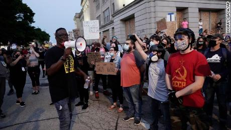 People gather Tuesday, August 25 to protest in Kenosha, Wisconsin. Anger over the Sunday shooting of Jacob Blake, a Black man, by police spilled into the streets for a third night. 