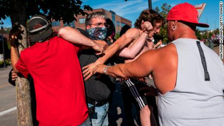 A Black Lives Matter protester scuffles with attendees of a pro-Trump rally during an event held to show support for the president on August 29, 2020 in Clackamas, Oregon.