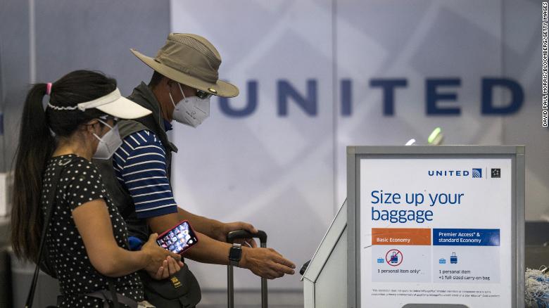 A traveler wearing a protective mask uses a kiosk to check-in at a United Airlines Holdings Inc. counter at San Francisco International Airport (SFO) in San Francisco, California, U.S., on Tuesday, Aug. 11, 2020. 