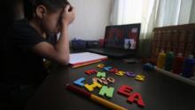 CANCUN, MEXICO - AUGUST 24: Student reacts during the start of the school year from home on August 24, 2020 in Cancun, Mexico. Mexican government will not allow in-person lessons this year and has developed a remote education system based on TV broadcasting. "Aprende en Casa" ("learn at home") program will support around 30 million students in the country in the 4 levels of basic education (kindergarten, preschool, elementary and secondary school) during the Covid-19 pandemic. Books will be available in an online platform and over 4,000 educational TV programs have been prepared to be broadcasted in different channels. According to official statistics, 56% of households have access to internet while 93% have a television. Radio programs will also be used to reach those kids with no connection nor TV, specially at indigenous communities. (Photo by Medios y Media/Getty Images)