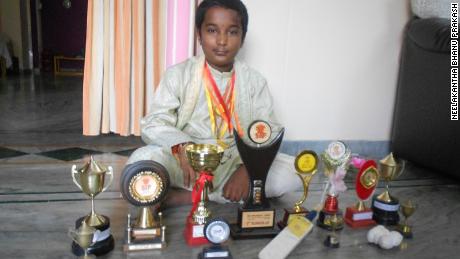 Bhanu, aged 10, poses with his haul of math tournament trophies in 2010.