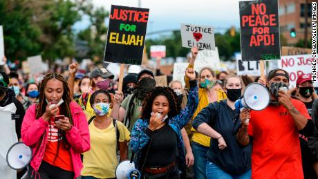 People march in the street to protest the death of Elijah McClain on July 25, 2020 in Aurora, Colorado.