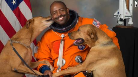 Melvin&#39;s now-famous NASA portrait features his two rescue dogs, Jake and Scout, who he secretly smuggled into NASA for the photo shoot.