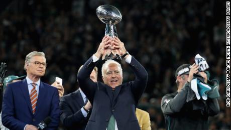 Lurie holds up the Vince Lombardi Trophy after his teams 41-33 victory over the New England Patriots.