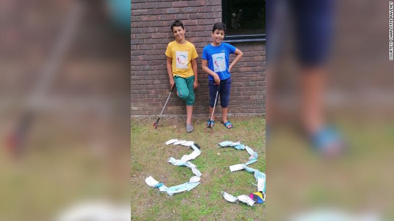 These brothers are picking up littered face masks around their neighborhood