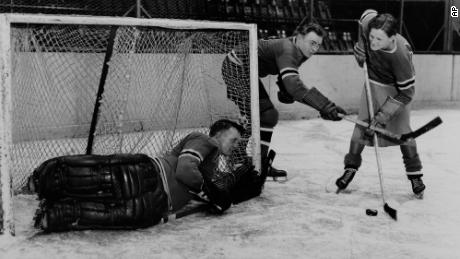 Didrikson (right) works out with the New York Rangers players Murray Murdock (center) and Andy Aitkenhead, goalie, in Madison Square Garden in New York City in 1933.