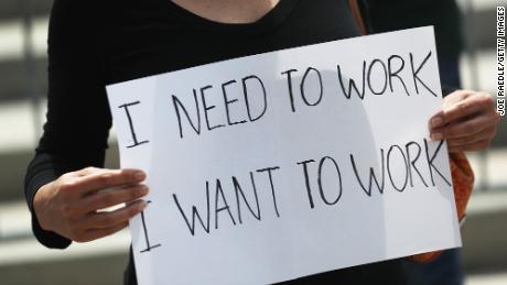 A protester holds a sign that reads, &#39;I need to work, I want to work,&#39; as she joins with restaurant owners, workers and supporters to protest new measures stating restaurants must close their indoor seating to combat the rise in coronavirus cases on July 10, 2020 in Miami, Florida. Restaurant owners in Miami-Dade County say county Mayor Carlos Gimenez&#39;s decision to close restaurant dining halls amid the surge in COVID-19 cases is unfair to them as other businesses stay open. Protest organizers claim there is no clear evidence that closing them is part of a realistic plan that will effectively manage the current crisis in the spread of COVID and they should be able to stay open. (Photo by Joe Raedle/Getty Images)