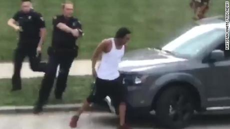In this screengrab taken from video, police follow Jacob Blake as he walks to the driver&#39;s side door of an SUV on August 23. He was shot moments later. 