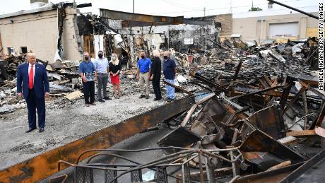 President Donald Trump tours an area affected by civil unrest in Kenosha on September 1.