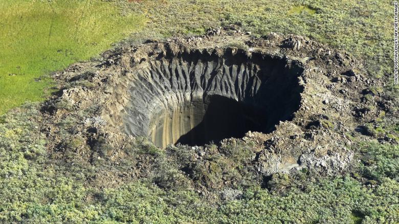 An aerial view taken from a helicopter on August 25, 2014, shows a crater on the Yamal Peninsula, northern Siberia. It was the first to be discovered in 2013. 