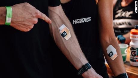Gatorade&#39;s Gx Sweat Patch shown on an Ironman athlete during an event in Kona Hawaii. The Gx Sweat Patch, expected to launch in 2021, relays data about sweat and sodium level to an app that provides personalized hydration and nutrition recommendations.